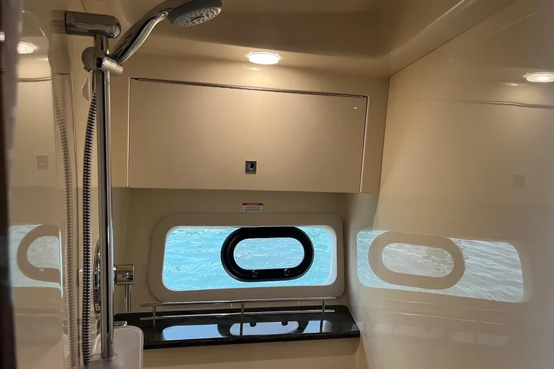 Godsend Yacht Photos Pics Interior of 2015 Sea Ray 470 Sundancer yacht bathroom with shower and window view.
