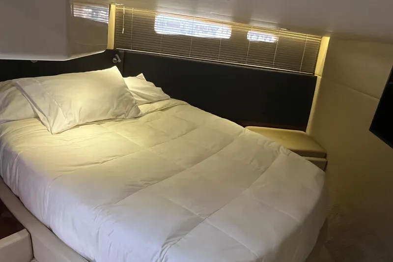 Godsend Yacht Photos Pics Luxurious bedroom interior of 2015 Sea Ray 470 Sundancer yacht with cozy bedding.