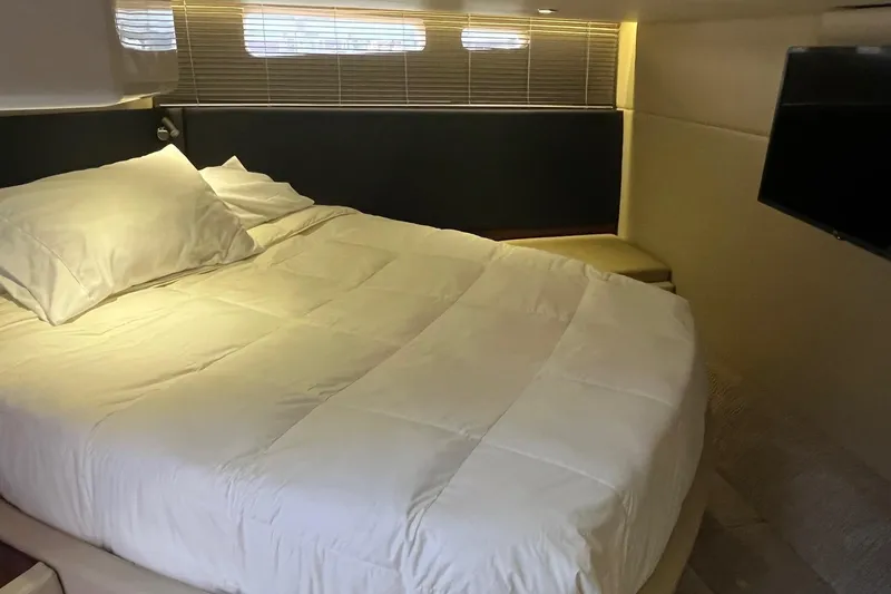 Godsend Yacht Photos Pics Luxurious bedroom interior of 2015 Sea Ray 470 Sundancer yacht with cozy bedding and TV.