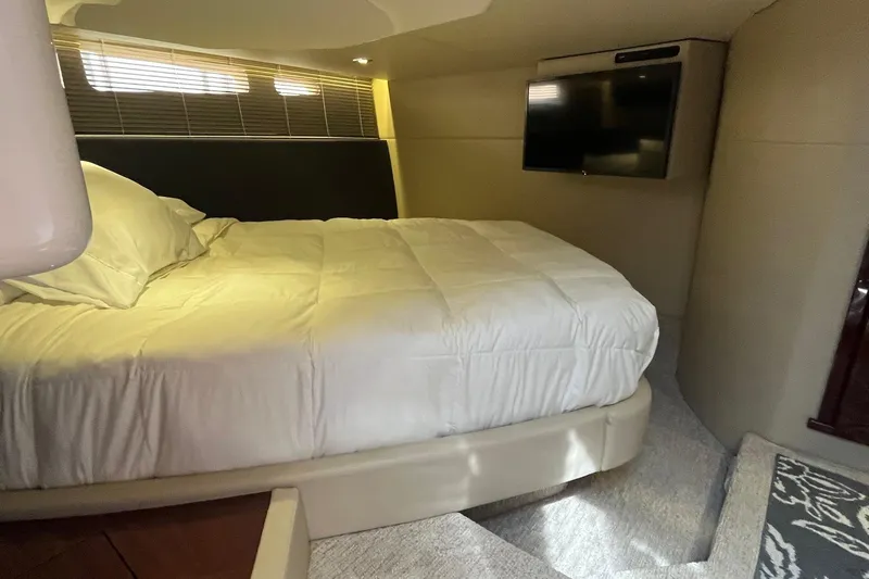 Godsend Yacht Photos Pics Luxurious bedroom interior of 2015 Sea Ray 470 Sundancer yacht with TV and cozy bedding.