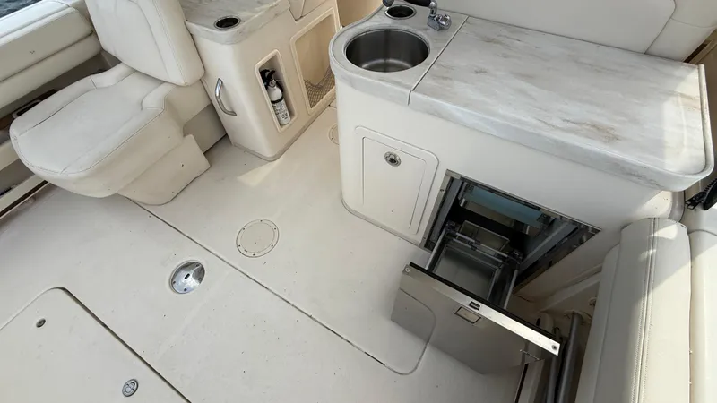 Aletha P Llc Yacht Photos Pics 2016 Grady-White Freedom 307 boat interior with seating, sink, and storage.