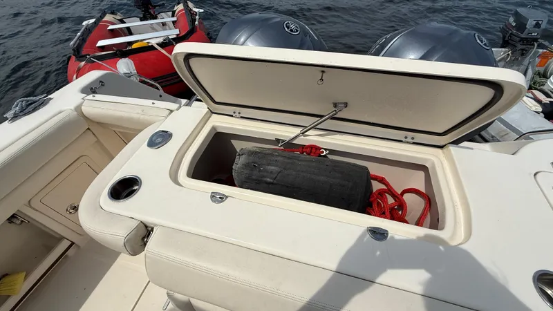 Aletha P Llc Yacht Photos Pics Open storage compartment on 2016 Grady-White Freedom 307 boat with red rope and fender.