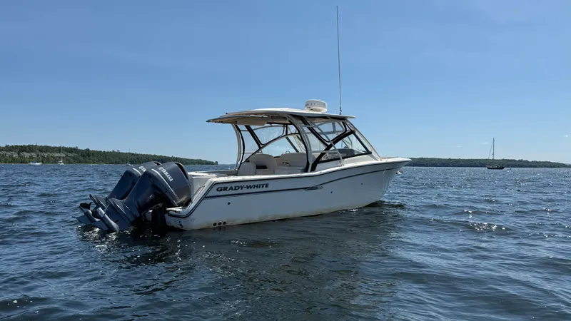 Aletha P Llc Yacht Photos Pics 2016 Grady-White Freedom 307 boat on calm water under clear blue sky.