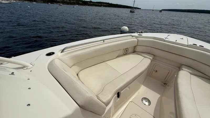 Aletha P Llc Yacht Photos Pics 2016 Grady-White Freedom 307 boat interior with cushioned seating on calm water.