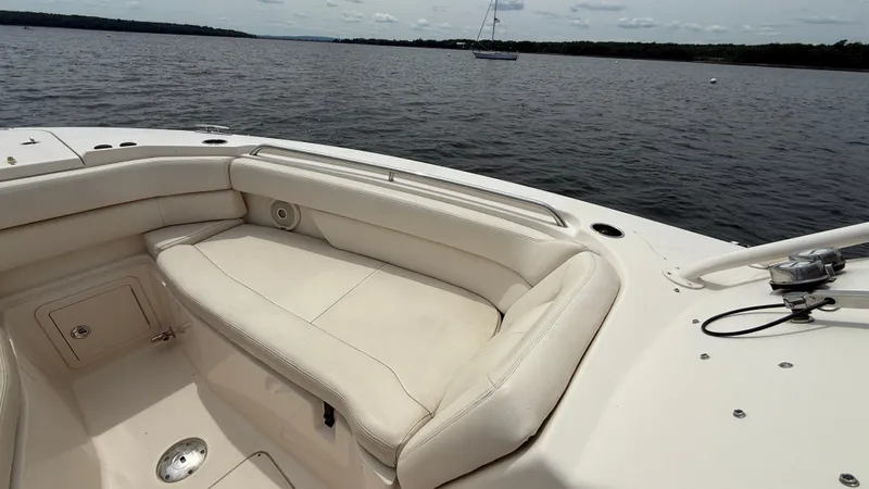 Aletha P Llc Yacht Photos Pics 2016 Grady-White Freedom 307 boat interior with cushioned seating on calm water.