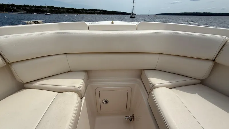 Aletha P Llc Yacht Photos Pics 2016 Grady-White Freedom 307 boat interior with beige seating, overlooking a calm lake.