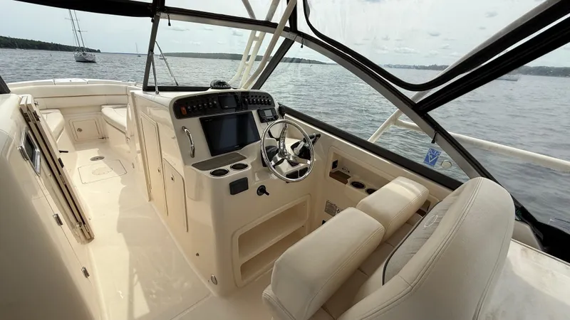 Aletha P Llc Yacht Photos Pics 2016 Grady-White Freedom 307 boat interior with helm, seats, and water view.