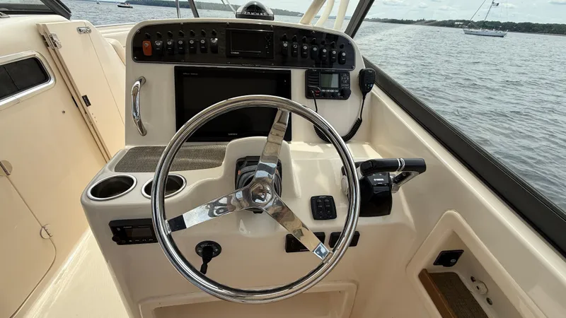 Aletha P Llc Yacht Photos Pics 2016 Grady-White Freedom 307 boat helm with steering wheel and control panel.
