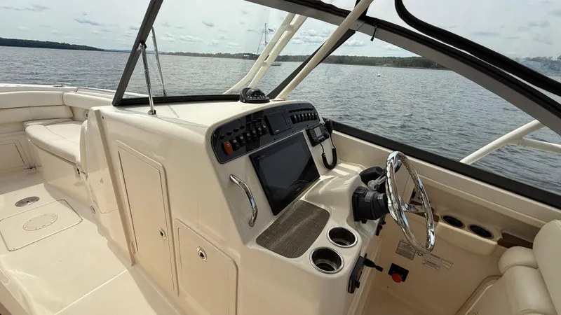 Aletha P Llc Yacht Photos Pics 2016 Grady-White Freedom 307 boat interior with steering wheel and control panel.