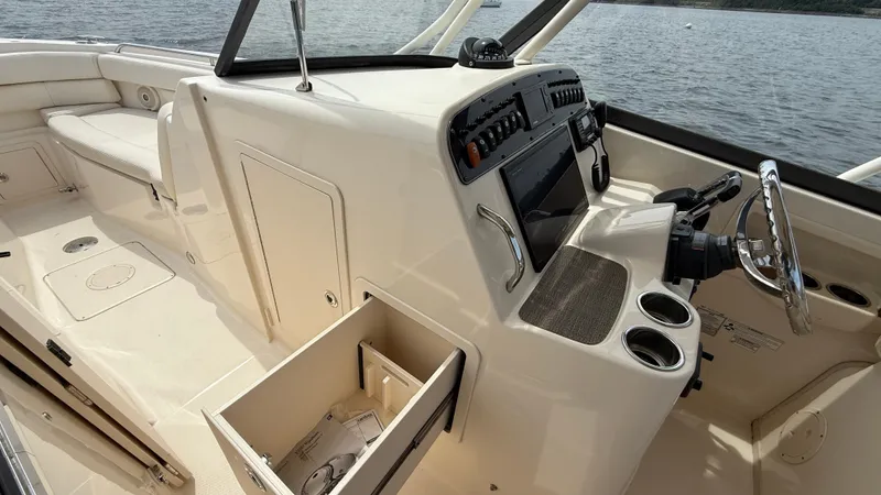 Aletha P Llc Yacht Photos Pics 2016 Grady-White Freedom 307 boat interior with helm, storage, and seating.