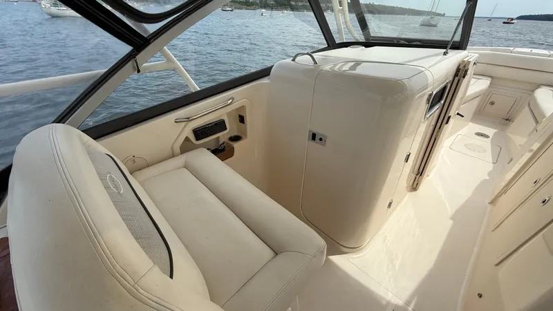 Aletha P Llc Yacht Photos Pics 2016 Grady-White Freedom 307 boat interior with seating and console, on calm water.