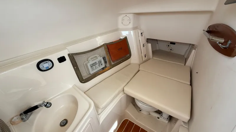 Aletha P Llc Yacht Photos Pics 2016 Grady-White Freedom 307 boat interior with sink, cushioned seating, and storage.
