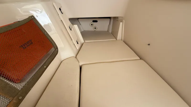 Aletha P Llc Yacht Photos Pics 2016 Grady-White Freedom 307 cabin interior with cushioned seating and storage net.