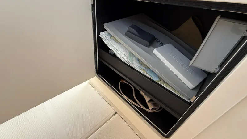 Aletha P Llc Yacht Photos Pics Storage compartment in 2016 Grady-White Freedom 307 boat with maps and equipment.