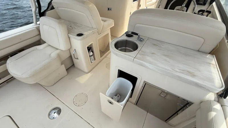 Aletha P Llc Yacht Photos Pics 2016 Grady-White Freedom 307 boat interior with seating, sink, and storage.