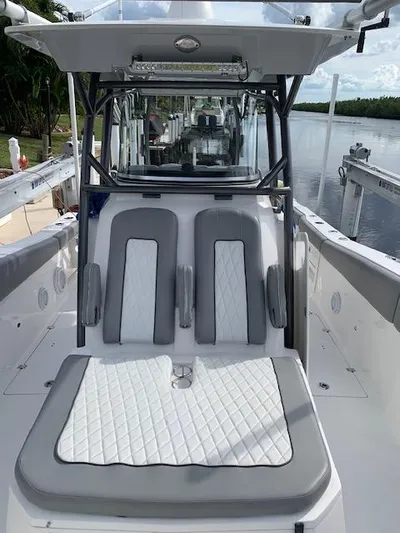  Yacht Photos Pics 2017 Sea Fox 328 Commander boat interior with cushioned seating, docked by a serene waterway.