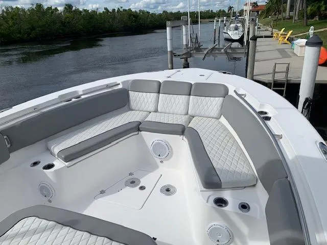  Yacht Photos Pics 2017 Sea Fox 328 Commander boat with spacious seating, docked by a scenic river.