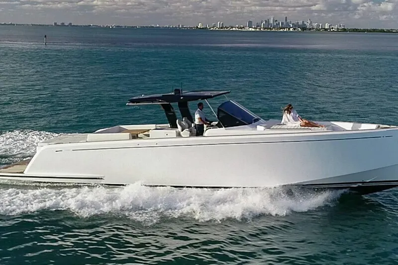  Yacht Photos Pics 2023 Pardo Yachts 50 cruising on open water with city skyline in background.