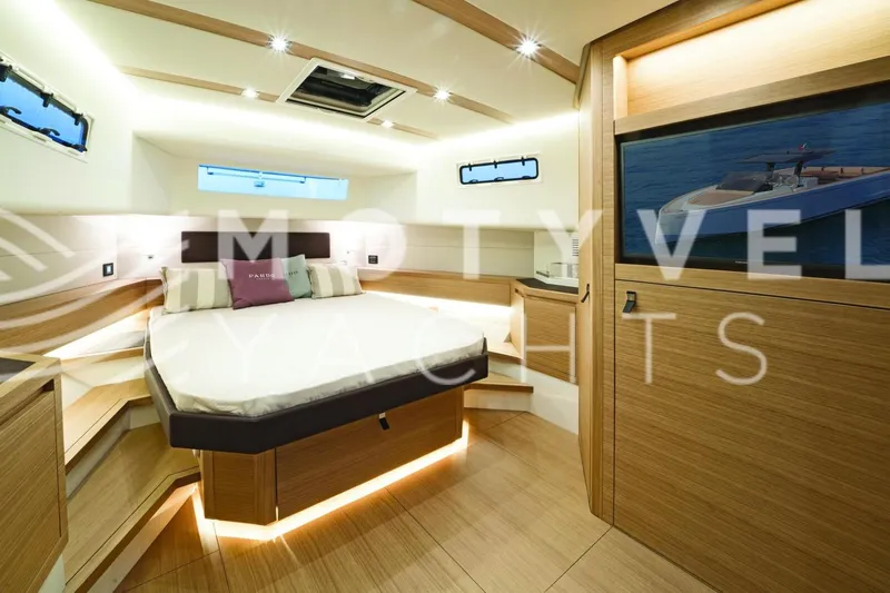  Yacht Photos Pics Luxurious interior of 2023 Pardo Yachts 50 with modern wood finish and cozy bed.