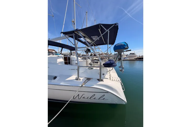 Wailele Yacht Photos Pics Hunter 44 Deck Salon 2007 sailboat docked in marina, featuring sleek design and blue canopy.