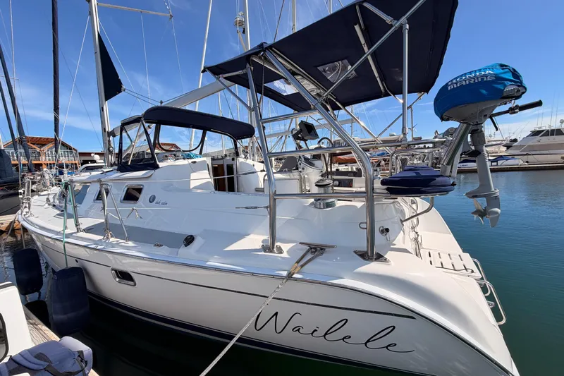 Wailele Yacht Photos Pics 2007 Hunter 44 Deck Salon sailboat docked in marina, featuring sleek design and blue canopy.