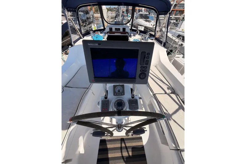 Wailele Yacht Photos Pics Cockpit view of 2007 Hunter 44 Deck Salon sailboat with navigation equipment.