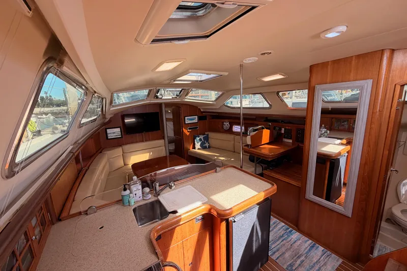 Wailele Yacht Photos Pics Luxurious interior of 2007 Hunter 44 Deck Salon yacht with spacious seating and modern amenities.