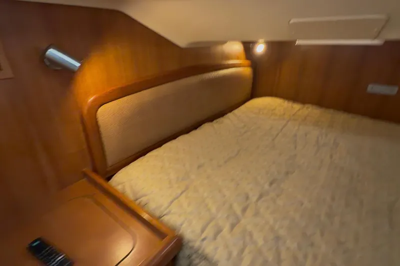 Wailele Yacht Photos Pics Cozy cabin interior of 2007 Hunter 44 Deck Salon with warm lighting and wooden accents.