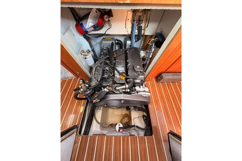 Wailele Yacht Photos Pics Engine compartment of 2007 Hunter 44 Deck Salon with visible components and wooden flooring.
