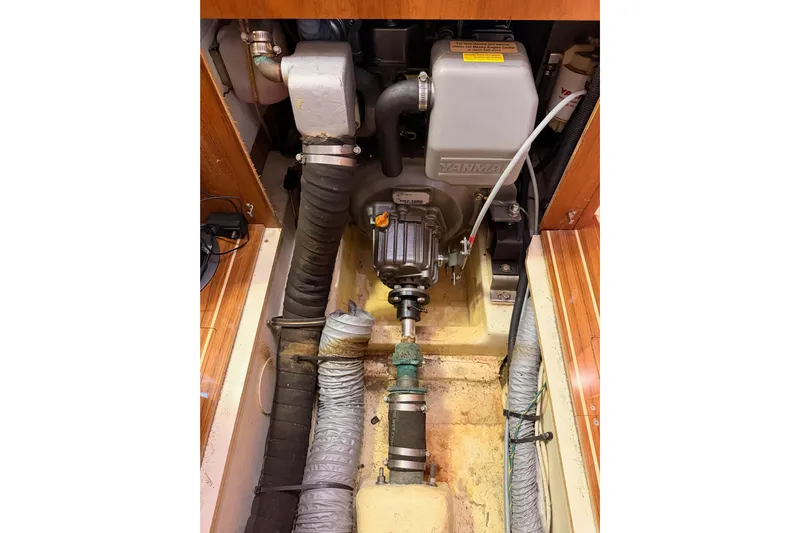 Wailele Yacht Photos Pics Engine compartment of a 2007 Hunter 44 Deck Salon sailboat, featuring a Yanmar engine.