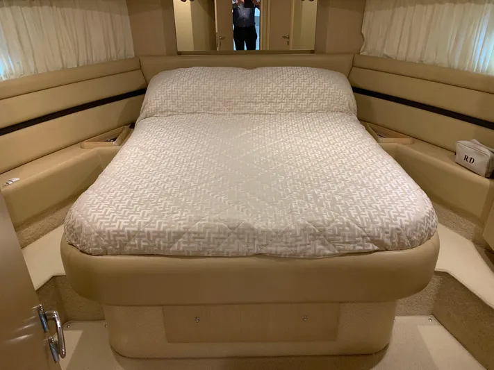  Yacht Photos Pics Luxurious bedroom interior of 2005 Ferretti Yachts 550 with elegant bedding and ambient lighting.