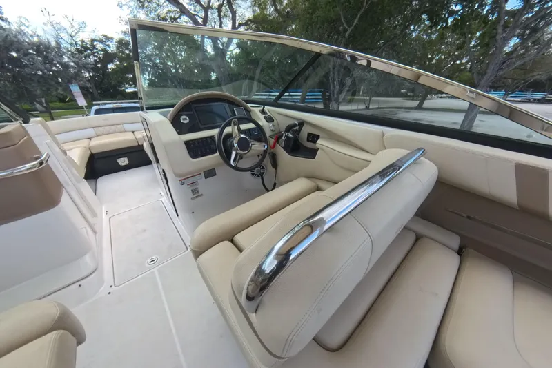  Yacht Photos Pics Interior view of 2018 Regal 29 OBX boat with beige seating and steering console.