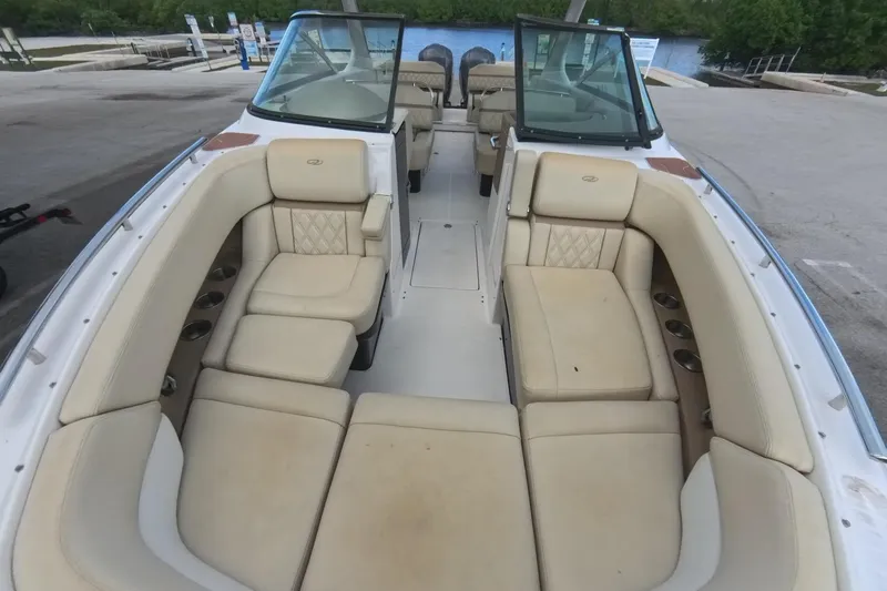  Yacht Photos Pics 2018 Regal 29 OBX boat interior with beige seating and cup holders, docked near water.