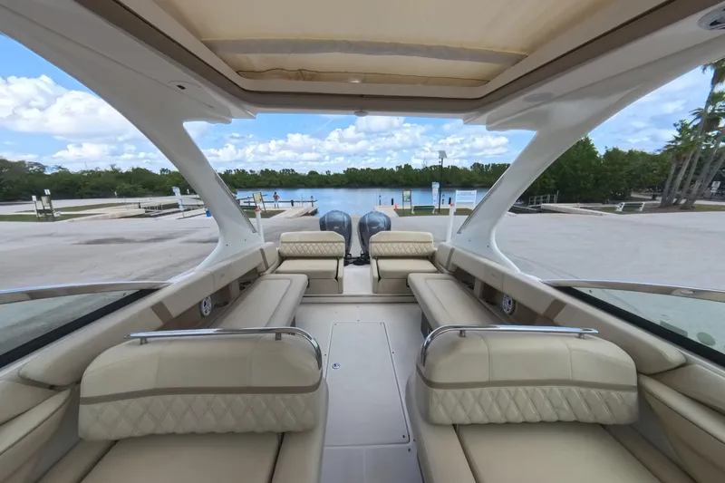  Yacht Photos Pics 2018 Regal 29 OBX boat interior with luxurious seating, docked by a scenic waterfront.
