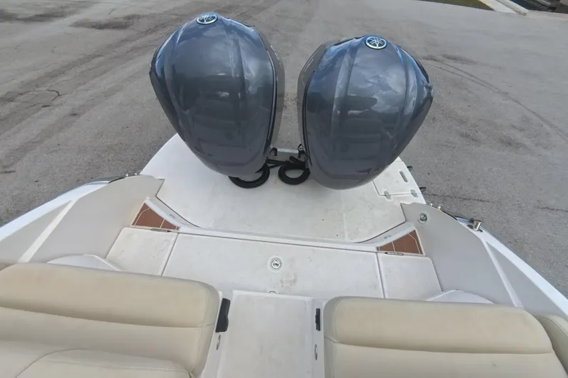  Yacht Photos Pics 2018 Regal 29 OBX boat with dual outboard motors, beige seating, and spacious deck.