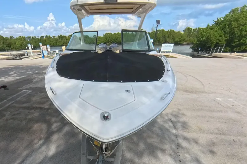  Yacht Photos Pics 2018 Regal 29 OBX boat on trailer at a sunny marina.
