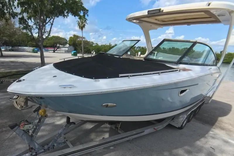  Yacht Photos Pics 2018 Regal 29 OBX boat on trailer, parked outdoors under clear sky.