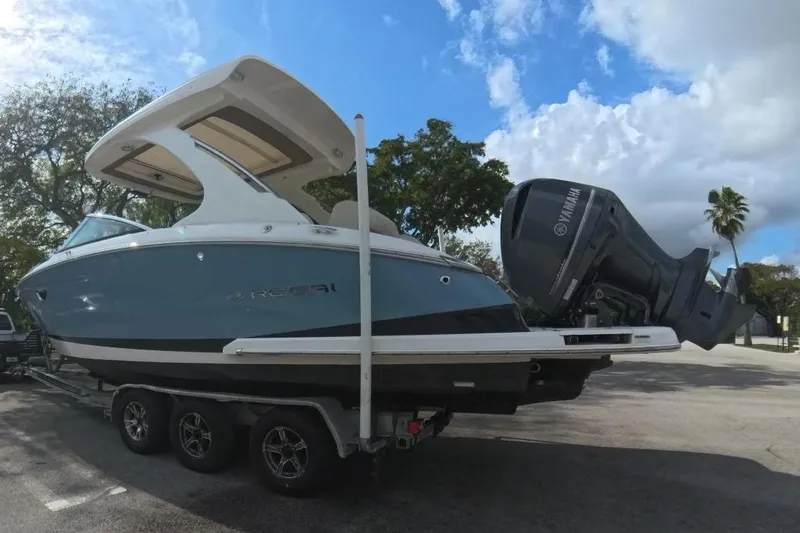  Yacht Photos Pics 2018 Regal 29 OBX boat on trailer in sunny parking lot.