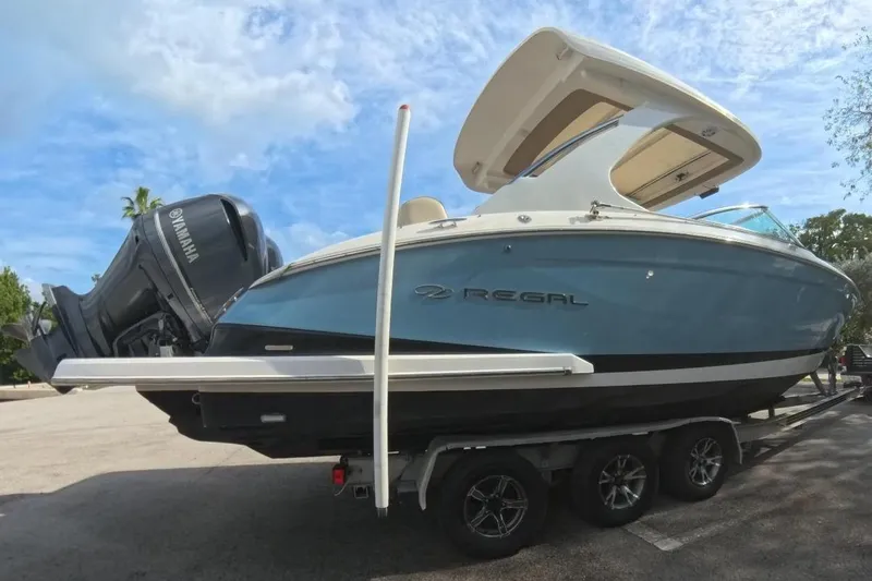  Yacht Photos Pics 2018 Regal 29 OBX boat on trailer, parked outdoors, with Yamaha outboard motor.