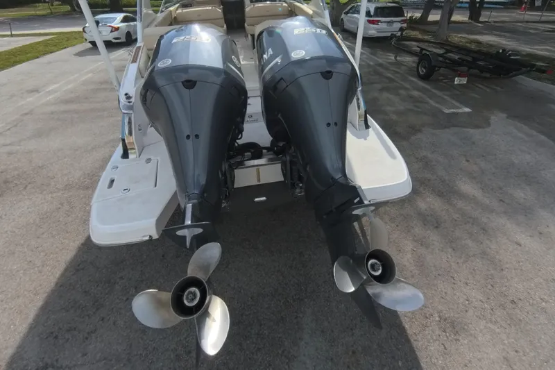  Yacht Photos Pics 2018 Regal 29 OBX boat with dual outboard engines in a parking area.