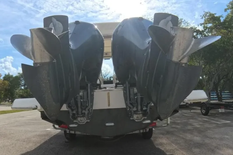 Yacht Photos Pics 2018 Regal 29 OBX boat with dual outboard engines in a sunny parking lot.