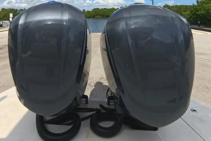  Yacht Photos Pics 2018 Regal 29 OBX boat with dual outboard motors at a sunny dock.