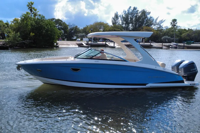  Yacht Photos Pics 2018 Regal 29 OBX boat on water, blue hull, dual Yamaha engines, scenic background.