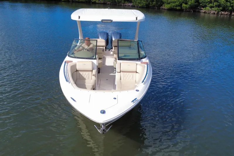  Yacht Photos Pics 2018 Regal 29 OBX boat cruising on calm water, featuring spacious seating and sleek design.