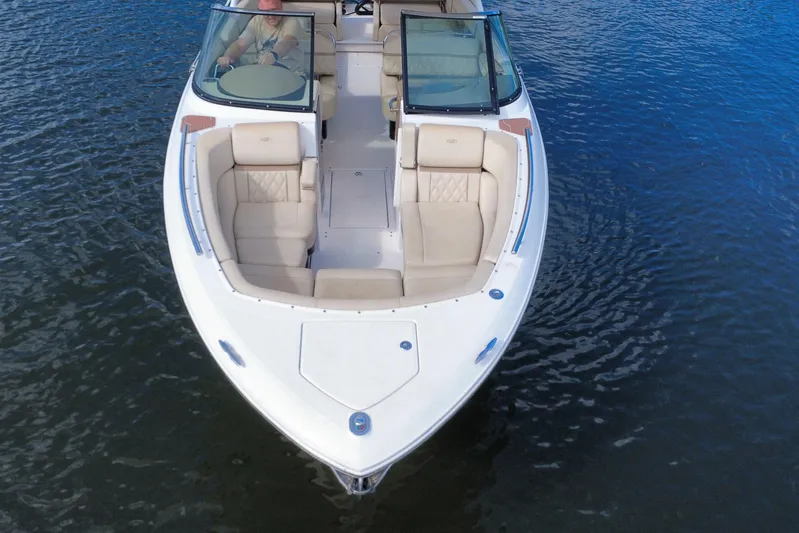  Yacht Photos Pics 2018 Regal 29 OBX boat with beige seating on calm water.
