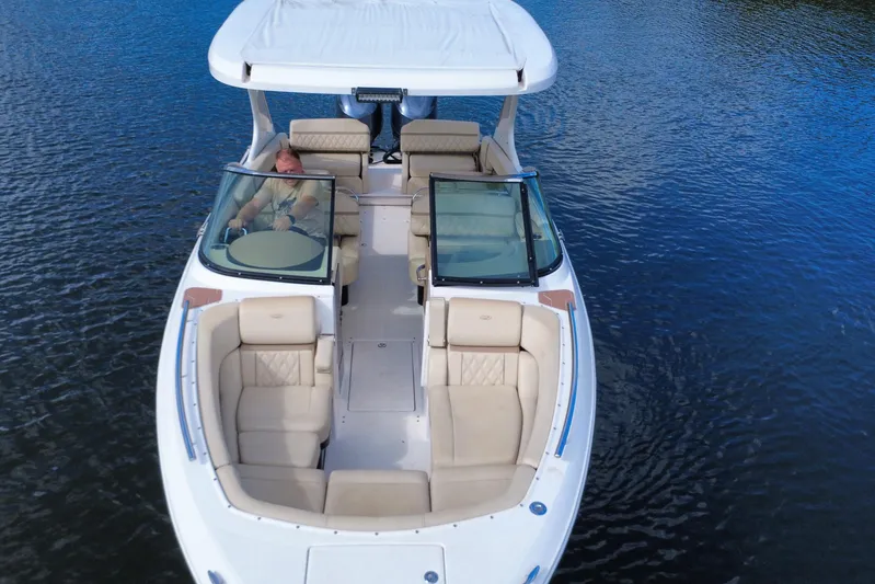 Yacht Photos Pics 2018 Regal 29 OBX boat on water, featuring spacious seating and sleek design.