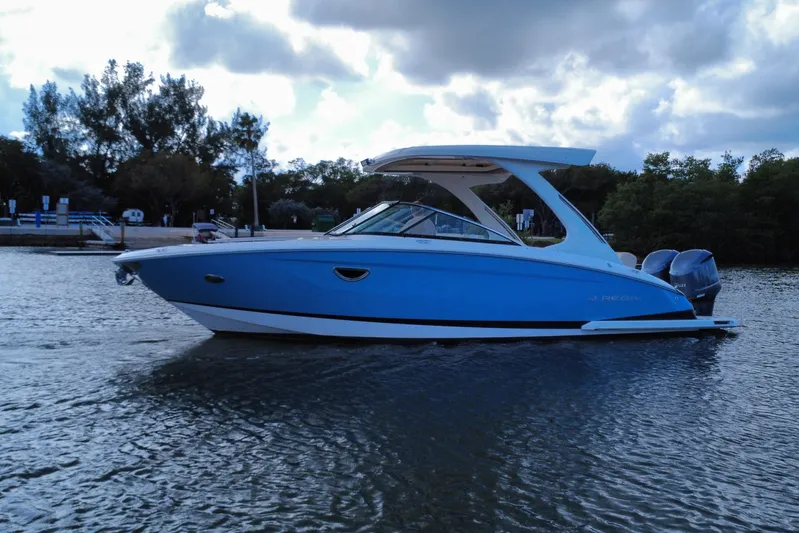  Yacht Photos Pics 2018 Regal 29 OBX boat on calm water under cloudy sky.