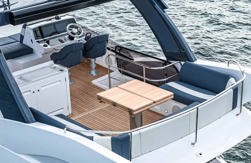  Yacht Photos Pics 2024 Sunseeker Manhattan 55 yacht with elegant deck and seating area on the water.