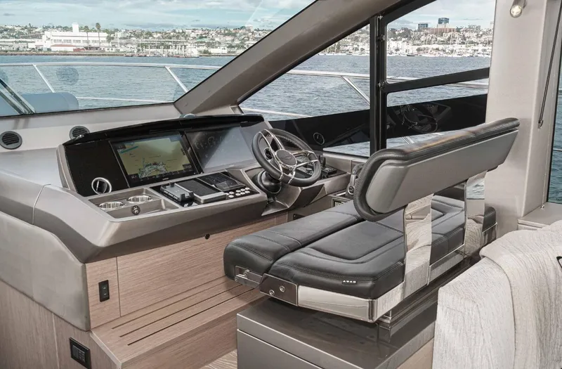  Yacht Photos Pics 2024 Sunseeker Manhattan 55 yacht helm with modern controls and luxurious seating.