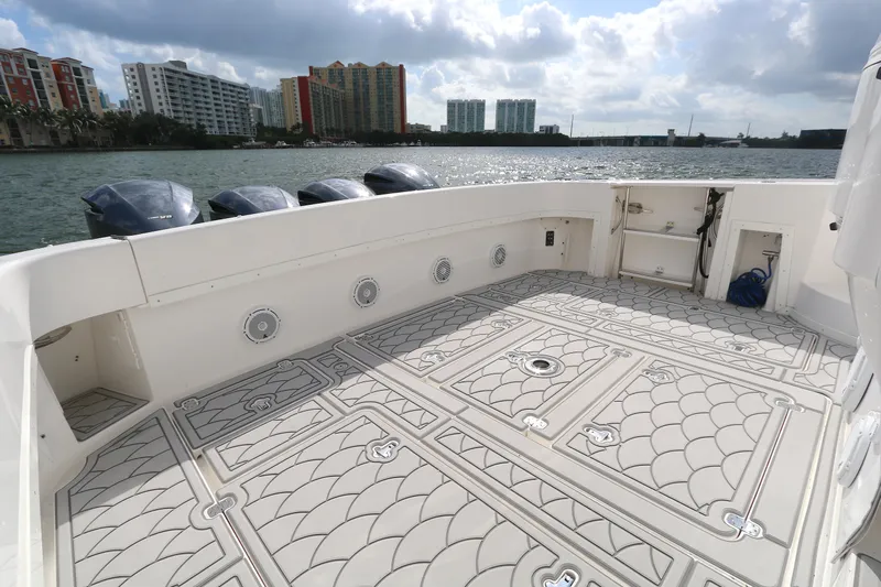  Yacht Photos Pics 2012 Intrepid 475 Sport Yacht deck with patterned flooring, overlooking waterfront cityscape.